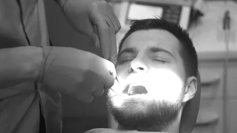 Man siting in dentist chair, pull up a tooth Stock Footage 81179839