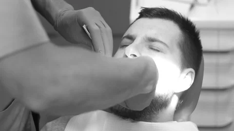 Man siting in dentist chair, pull up a tooth Stock Footage 81179845
