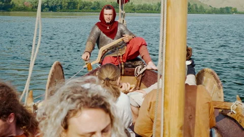 A Man Sits Aboard the Drakkar, Dressed in Armor, and Looks into the Distance. Stock Footage 156555969