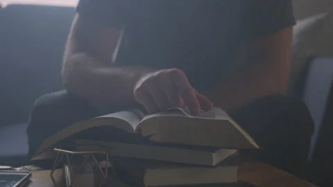 Man Sits Alone in His Apartment and Studies the Holy Scriptures Stock Footage 208747285
