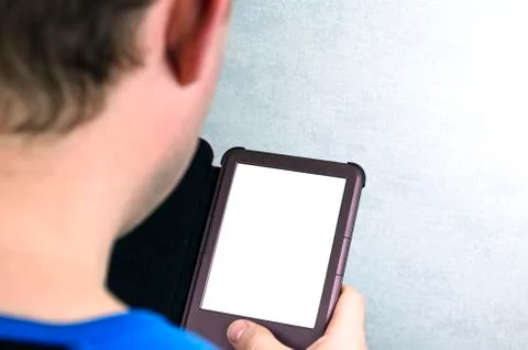 A man sits and reads an e-book. Modern technology, reading and education Stockfoto's