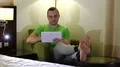 Man sits in armchair in hotel room and uses tablet computer HD Footage