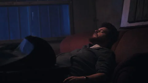 Man sits back high after bong hit Stock Footage 275103811