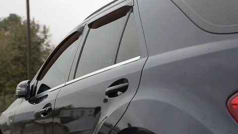 Man sits in black car Stock Footage 74731276