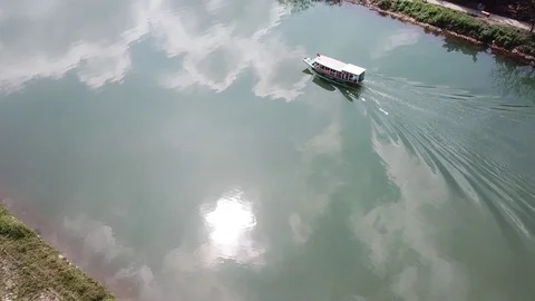 A man sits in a boat and controls it Stock Footage 128276274