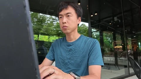 Man sits calmly, working on laptop Stock Footage 340436556