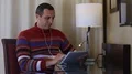 Man sits on chair at the table in hotel room and uses tablet computer HD Footage