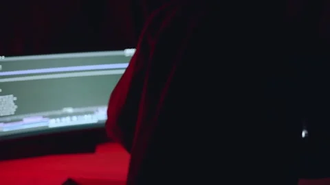 The man sits at the computer, the man sits in front of the monitors Stock Footage 309853621