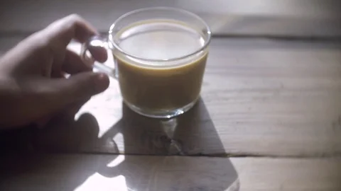 Man sits with cup of coffee at table Stock Footage 78503779