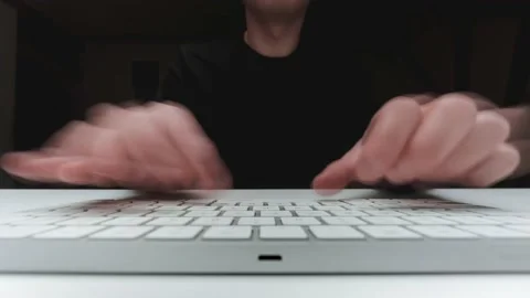 Man sits at a desk and types on a keyboard. Timelapse Video Footage 4K Video stock 150863893