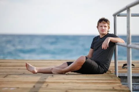 A man sits on the dock Stock Photos