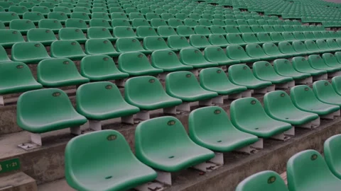 A man sits down in an armchair in an empty stadium Stock Footage 91877673