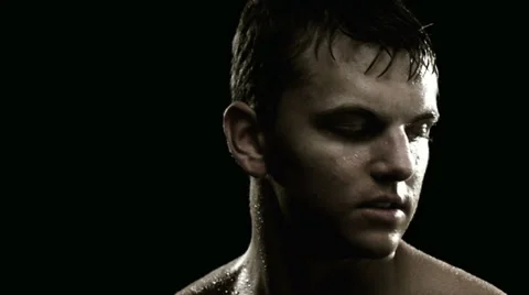 Man sits down to bench press and starts lifting Stock Footage 33831310