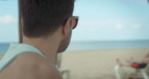 Man sits down in front of the sea Video stock 205022692