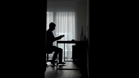 Man sits down at his desk in a dark room and starts programing / hacking / 스톡 동영상 122528139