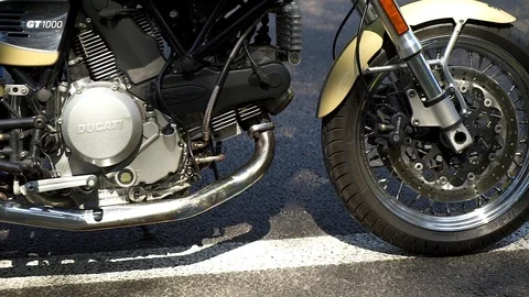  A man sits down on his motorcycle and looks out into the distance. Close-up, sl Stock Footage 88499586