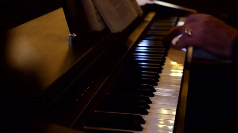 A man sits down to play the piano Stock Footage 41582515