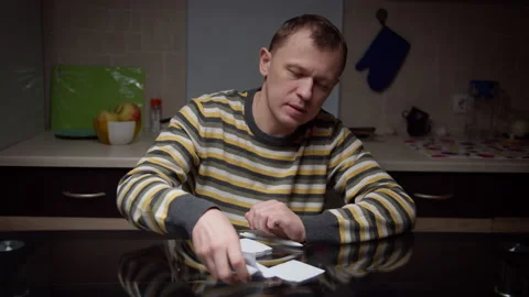 A man sits in the evening  in front of him stickers with plans, planning Stock Footage 134477922