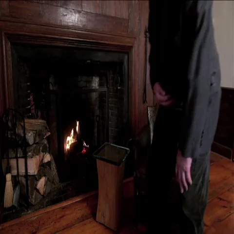 Man Sits by a Fireplace Stock Footage 69527694