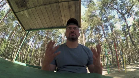 A man sits in the forest and talks Stock-Footage 196217360