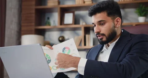 Man sits in front of computer at desk has video call, internet connection Stock Footage 220141825