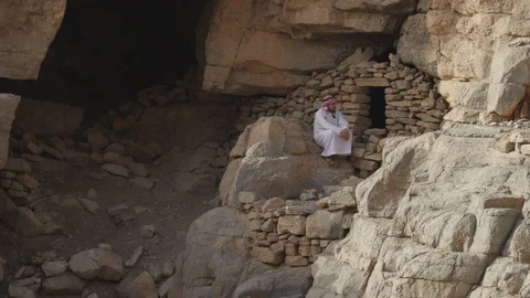 Man Sits in Front of Tomb in Middle East 4K Stock Footage 89181072