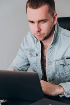 A man sits at home at a computer at a remote job Stock Photos