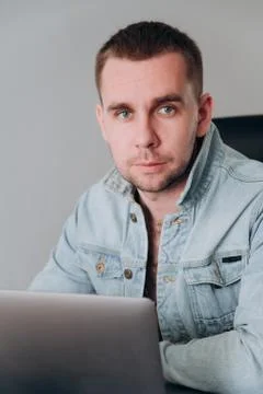 A man sits at home at a computer at a remote job Stock Photos