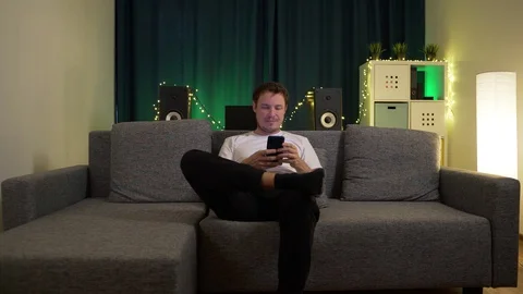 The man sits at home in isolation, does not know what to do Stock Footage 129384366