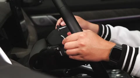 A man sits inside a car and presses various buttons, no one around, dark studio, Stock Footage 280224369