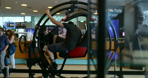 A man sits inside a human gyroscope simulator at the IFA trade show in Berlin Stock Footage 317697911