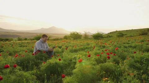 Man sits on the nature and does business conversation via tablet Video stock 62518892