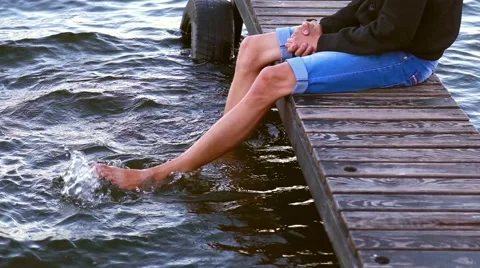 A man sits on a pier Video stock 53492307