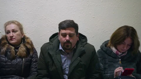 Man sits in queue and looking up dissatisfied shakes his head Stock Footage 144696419