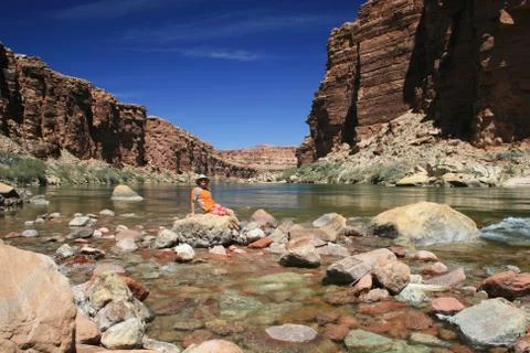 Man sits by river Stock Photos