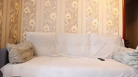 Man sits on the sofa, and switch the TV channels Stock Footage 72581701