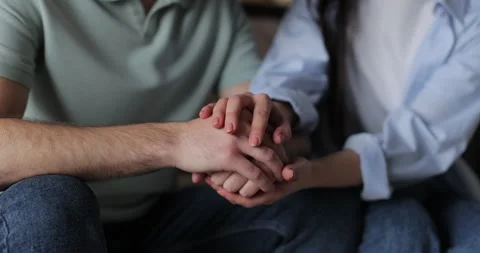Man sits on the sofa feeling sad, then his wife comes  sympathy and support. Stock Footage 302265154