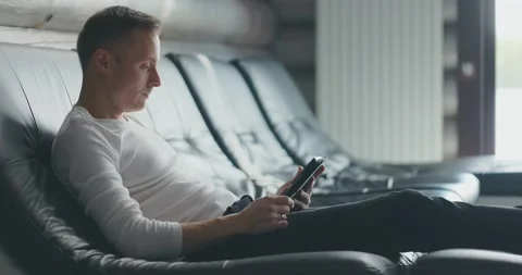 Man sits on sofa, uses tablet and rejoices at the received good news. Happy man Stock Footage 197572410