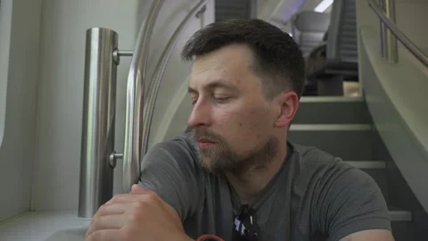 Man sits on staircase of a crowded double-decker train in Germany, as all seats Stock Footage 329428065