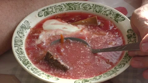 A man sits at a table and eats borscht Stock Footage 177152310