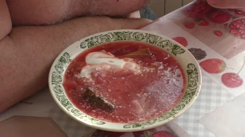 A man sits at a table and eats borscht Stock Footage 177152387