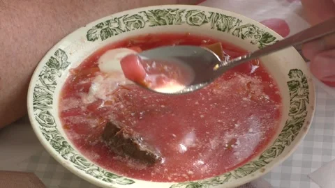 A man sits at a table and eats borscht Stock Footage 177156108