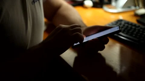 Man sits at the table and reading phone message. Stock Footage 152592260