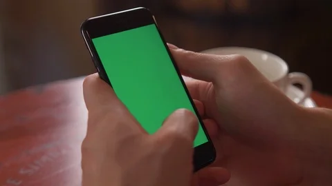 A man sits at table and runs his fingers across screen of the phone. Close-ap Stock Footage 106001165