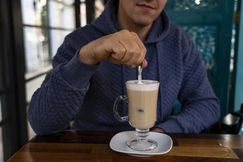 A man sits at a table in a cafe Stock Photos