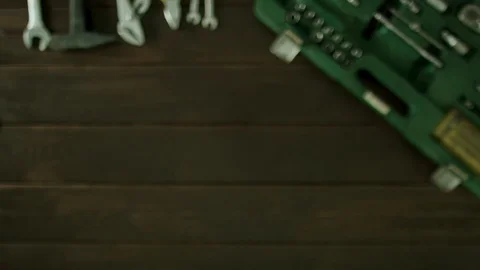 А man sits at a table near the toolbox and glue stickers on the desk. Stock Footage 82065173
