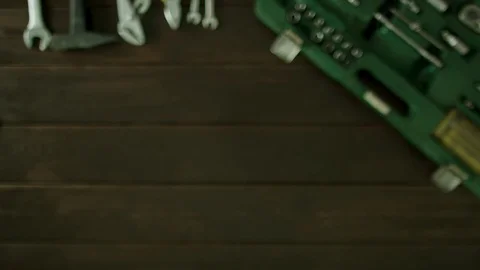 A man sits at a table near the tools are and pulls out bank card from his wallet Stock Footage 82065643