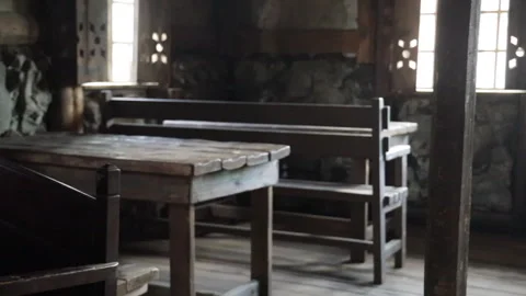A man sits at a table in a rustic bar Stock Footage 277021180
