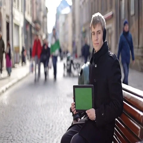 A man sits with tablet Stock Footage 69588771