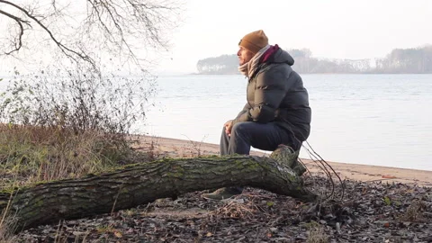 A man sits thoughtfully on a fallen tree 스톡 동영상 144219700